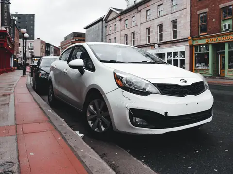 White sedan parked on a city street
